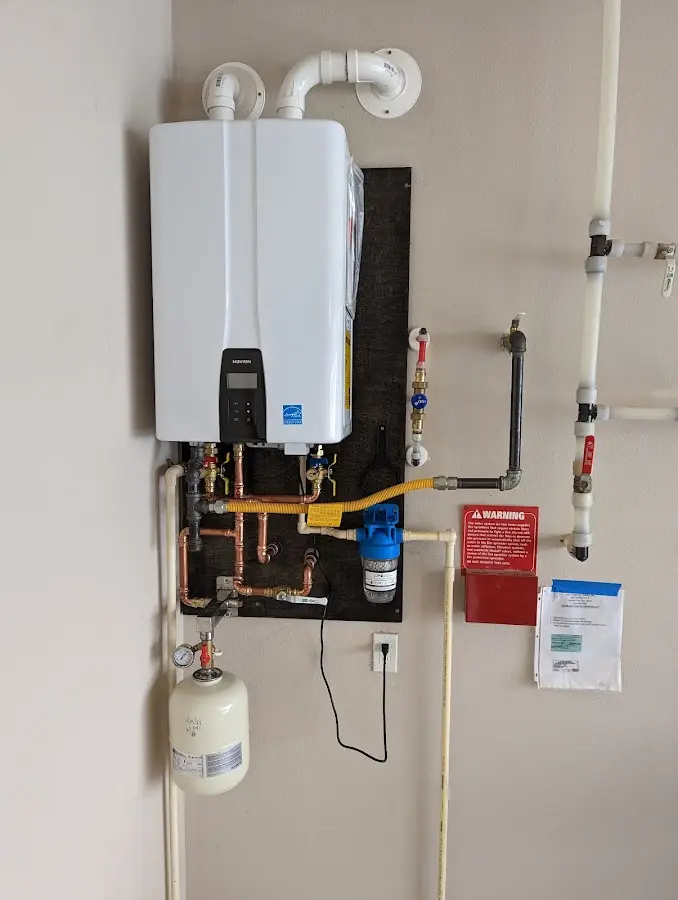 Professional plumber installing copper piping in a Manhattan home